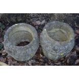 A PAIR OF CIRCULAR COMPOSITE GARDEN PLANTERS, with spandrels decoration