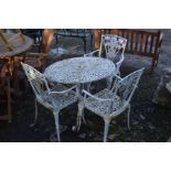 A CIRCULAR WHITE GROUND ALUMINIUM GARDEN TABLE, (broken leg) and three matching armchairs (4)