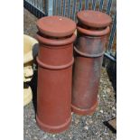 A PAIR OF TERRACOTTA CYLINDRICAL CHIMNEY POTS, with toppers, overall height 100cm x height minus