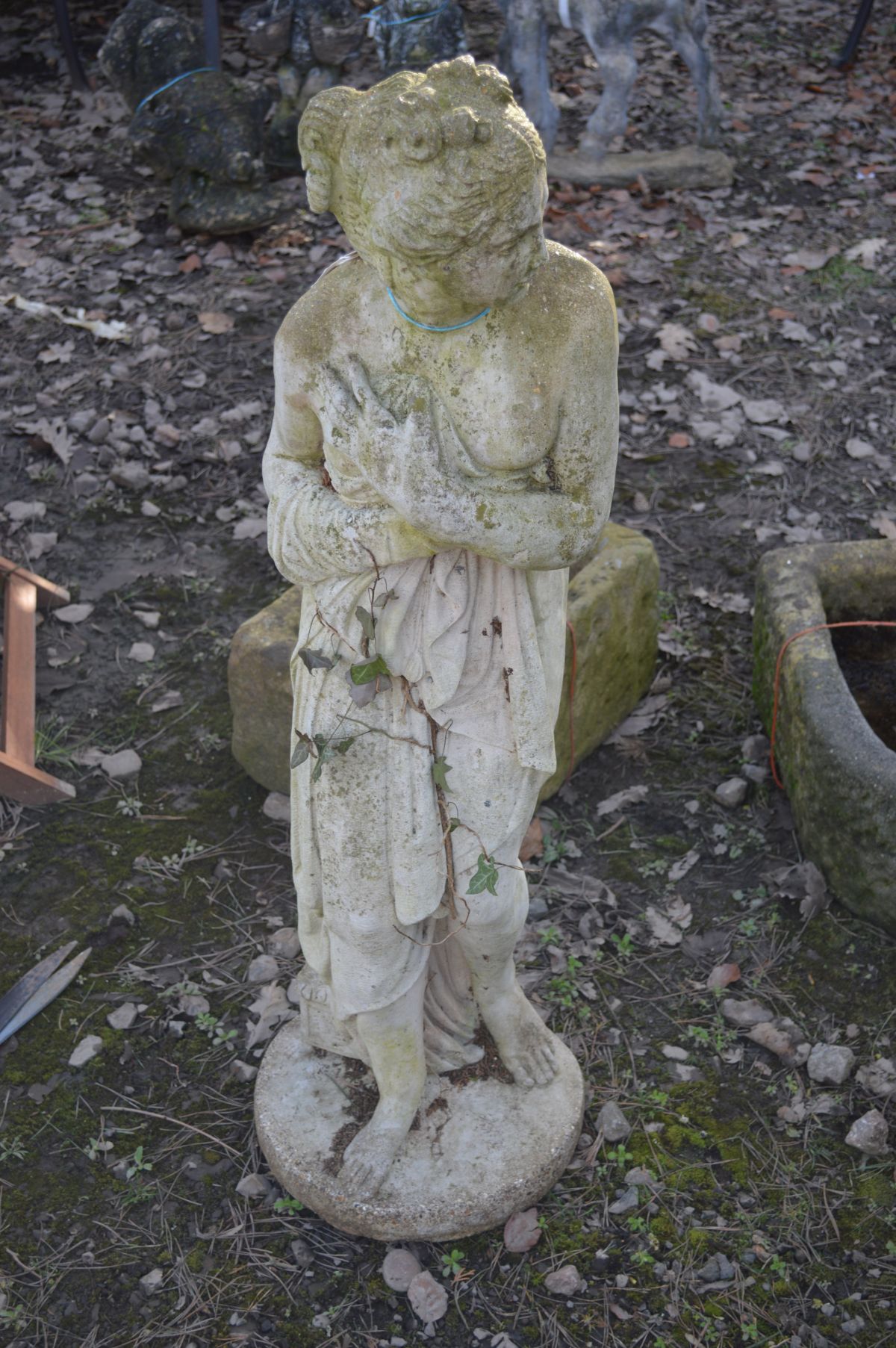 A COMPOSITE GARDEN FIGURE OF A STANDING SEMI CLAD WOMAN, height 117cm