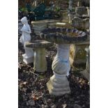 A COMPOSITE SHELL TOPPED BIRD BATH, height 82cm, together with a smaller composite bird bath and