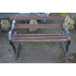 A VINTAGE BLACK GROUND CAST IRON SLATTED GARDEN BENCH, width 120cm