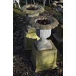 A PAIR OF COMPOSITE TULIP STYLE GARDEN URNS, on a separate cubed plinth, diameter 45cm overall x