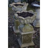 A PAIR OF COMPOSITE GARDEN URNS, on a separate plinth, diameter 54cm x overall height 84cm (2)