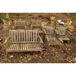 A TEAK FOUR PIECE GARDEN PATIO SET, comprising a two seater bench, a pair of armchairs and a