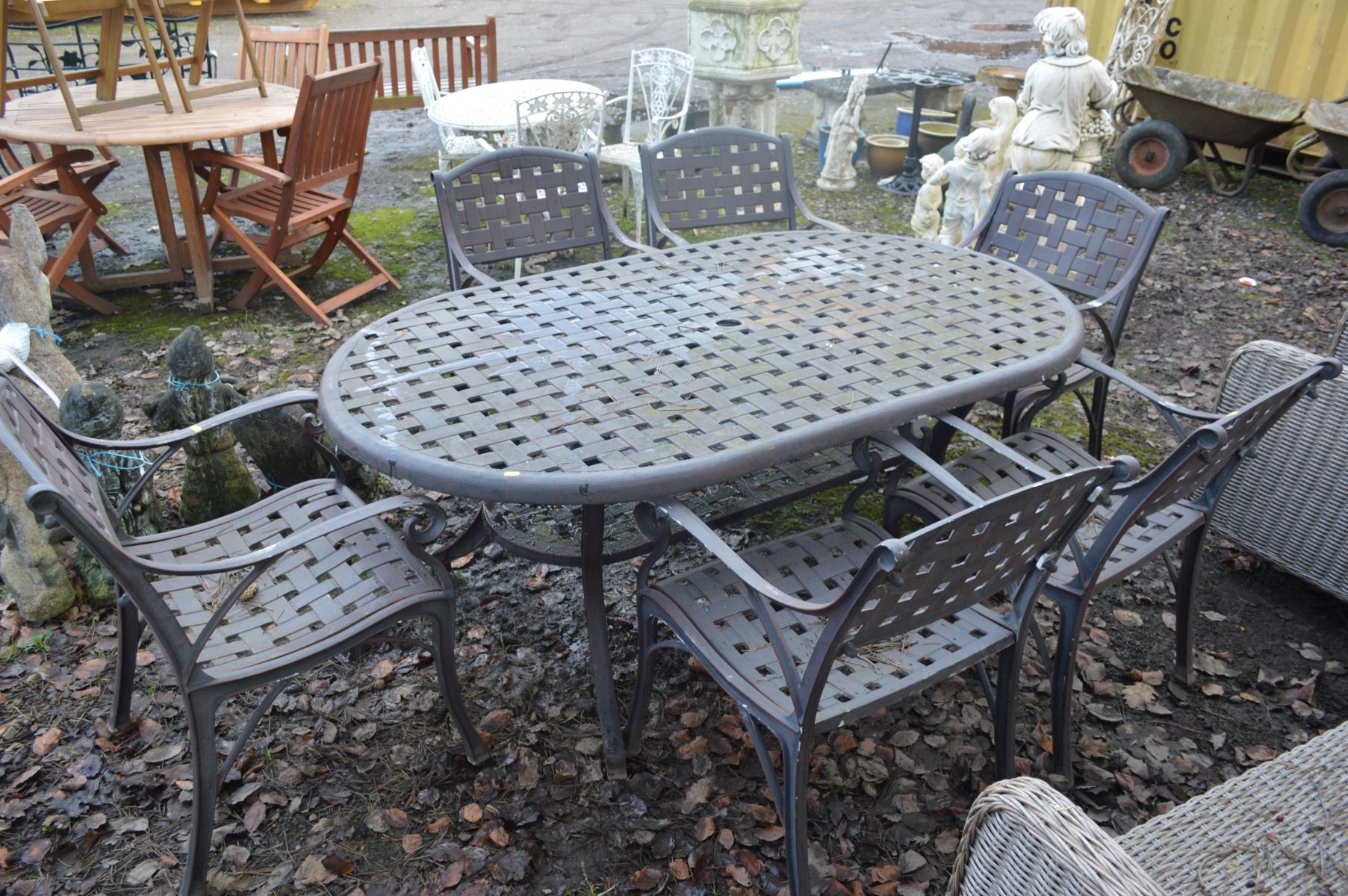 A WROUGHT IRON LATTICE GARDEN TABLE, with rounded corners and undershelf, width 183cm x depth 110cm,