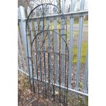 A BLACK GROUND WROUGHT IRON GARDEN GATE, with an arched top, width 92cm x 196cm, together with a