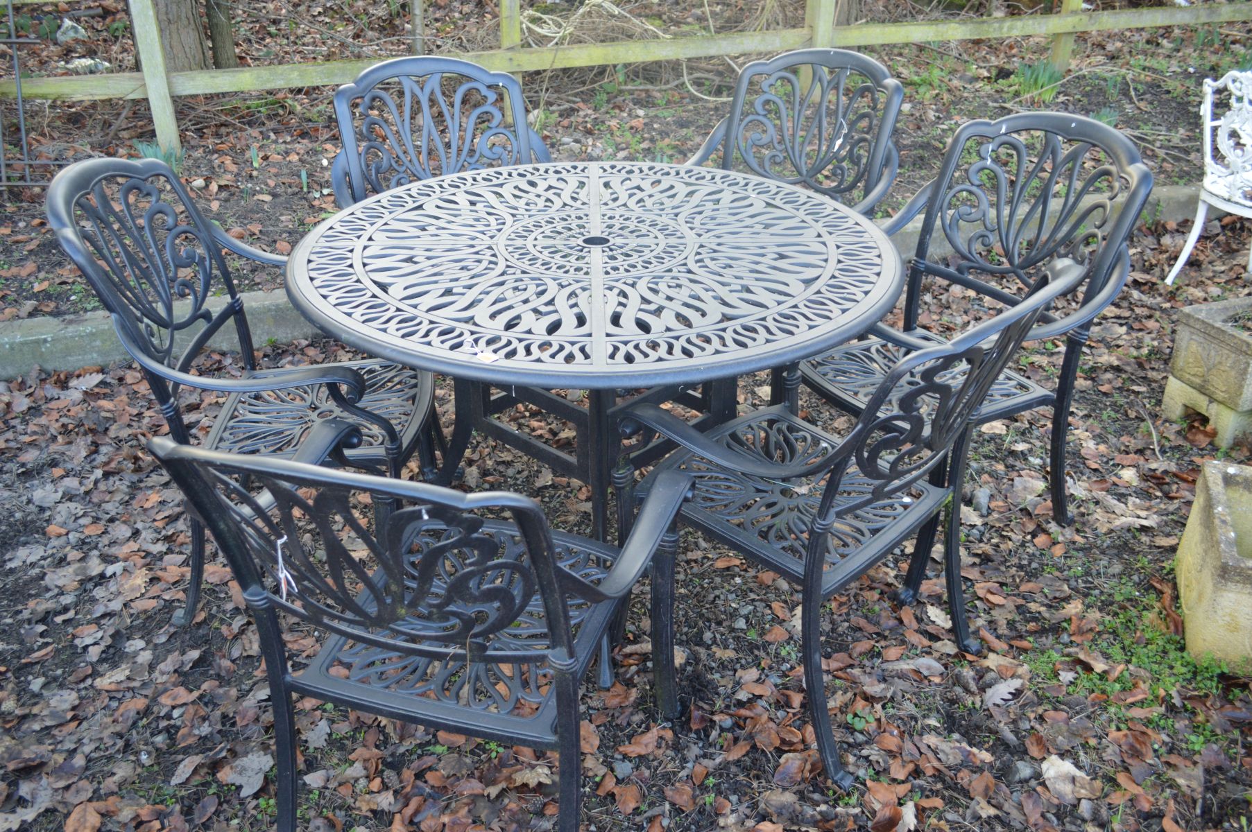 A MODERN ALUMINIUM BLACK GROUND CIRCULAR GARDEN TABLE, diameter 120cm x height 74cm and six