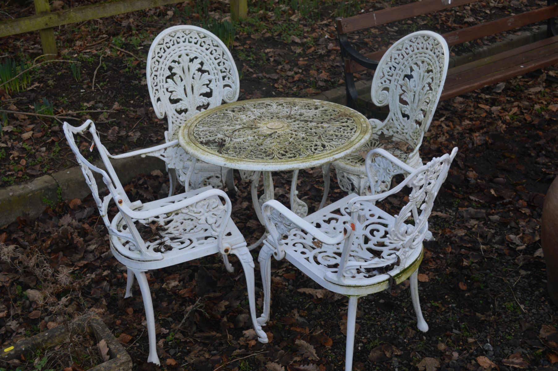 A WHITE PAINTED ALUMINIUM CIRCULAR GARDEN TABLE, diameter 69cm, together with a pair of matching