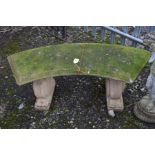 A COMPOSITE ARCHED GARDEN BENCH, on a twin scrolled base, width 120cm x height 48cm