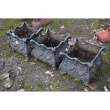 THREE BLACK GROUND CAST IRON GARDEN PLANTERS, with foliate decoration, 34cm square