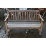 A TEAK SLATTED GARDEN BENCH, width 123cm togehter with a bespoke garden table made from horse