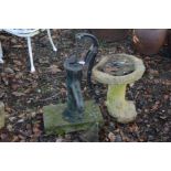A VICTORIAN BLACK PAINTED CAST IRON WATER PUMP, on a stone base, together with a composite bird bath