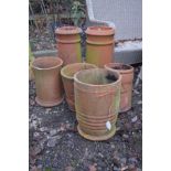TWO SIMILAR TERRACOTTA CYLINDRICAL CHIMNEY POTS, height 63cm, together with four various other