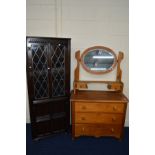 A GOLDEN OAK DRESSING CHEST, with an oval mirror and three drawers, together with a dark oak