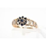 A 1970'S 9CT GOLD SAPPHIRE CLUSTER RING, the tiered cluster claw set with circular cut sapphires, to