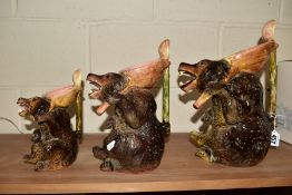 A GRADUATED SET LOF THREE MAJOLICA STYLE BEARS, the handles modelled as spoons, largest height