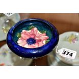 A MOORCROFT POTTERY LIPPED TRINKET DISH, 'Anemone' pattern on blue ground, diameter overall 11cm