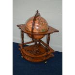 A REPRODUCTION BURR AMBOYNA AND MAHOGANY FINISH DRINKS GLOBE on orbit caster