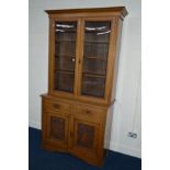 AN EDWARDIAN GOLDEN OAK DOUBLE GLAZED BOOKCASE, with two drawers, width 113cm x depth 50cm x