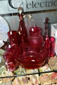A GROUP OF CRANBERRY COLOURED GLASS ITEMS, to include five various jugs, tallest 18cm, smallest 12.