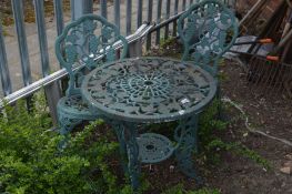A GREEN CAST ALUMINIUM CIRCULAR GARDEN TABLE, diameter 65cm a pair of matching chairs (sd) and a set