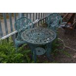 A GREEN CAST ALUMINIUM CIRCULAR GARDEN TABLE, diameter 65cm a pair of matching chairs (sd) and a set