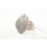 A 9CT GOLD DIAMOND DRESS RING, the marquise shape panel claw set with single cut diamonds in a