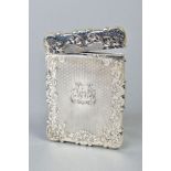 A MID VICTORIAN SILVER CARD CASE OF WAVY RECTANGULAR OUTLINE, foliate engraved and engine turned