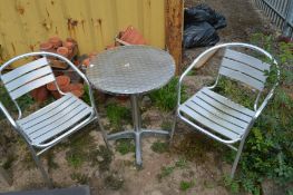 AN ALUMINIUM CIRCULAR BISTRO TABLE, diameter 60cm and two matching chairs (3)