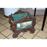 A 19TH CENTURY BLACK FOREST WOODEN PLANTER, with porcelain panel depicting a male figure playing the