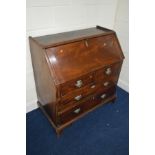 A GEORGIAN MAHOGANY BUREAU, with a fitted interior and four drawers, width 99cm x depth 54cm x