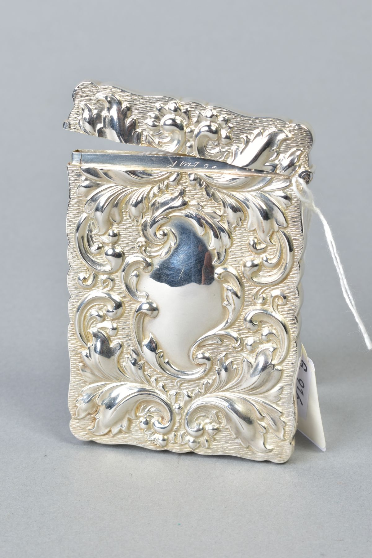 AN EDWARDIAN SILVER CARD CASE OF WAVY RECTANGULAR OUTLINE, repousse decorated with foliate - Image 2 of 2