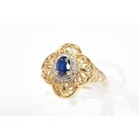 A SAPPHIRE AND DIAMOND CLUSTER RING, the central oval cut sapphire within a surround set with four