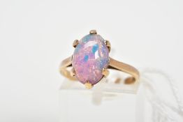 A 9CT GOLD DRESS RING, designed with an oval foil glass cabochon imitating an opal in a six claw