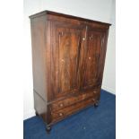 A GEORGIAN MAHOGANY PANELLED TWO DOOR LINEN PRESS with a single linen slide above two long drawers