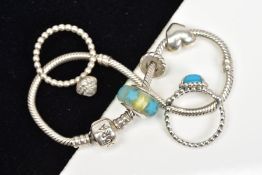 A PANDORA BRACELET AND TWO PANDORA RINGS, the charm bracelet suspending three charms, both rings