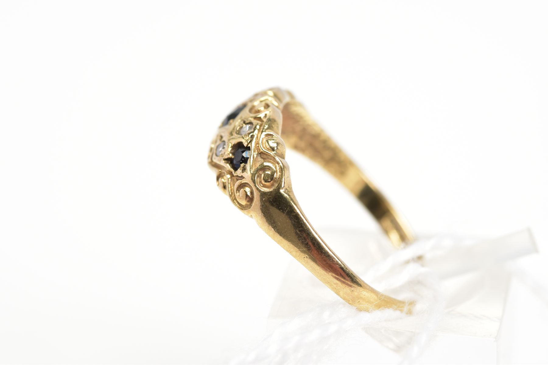 A 9CT GOLD SAPPHIRE AND DIAMOND RING, designed as three graduated circular cut sapphires within a - Image 2 of 3