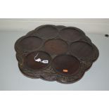 A LATE 19TH CENTURY MAHOGANY STAINED OAK LAZY SUSAN, of wavy outline, the border carved with ears of