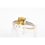 A 9CT GOLD CITRINE RING, designed with a central cushion shape citrine and circular colourless