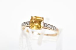 A 9CT GOLD CITRINE RING, designed with a central cushion shape citrine and circular colourless