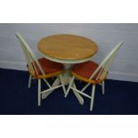 A MODERN CIRCULAR BEECH AND PAINTED PEDESTAL KITCHEN TABLE and two matching chairs (3)