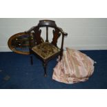 AN EDWARDIAN MAHOGANY CORNER CHAIR together with an oak oval wall mirror and a pair of pink stripped