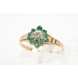 A 9CT GOLD EMERALD AND DIAMOND CLUSTER RING, the central single cut diamond within a star illusion