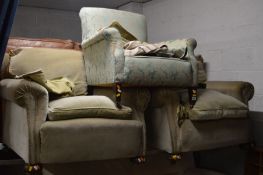 A PAIR OF EARLY 20TH CENTURY GREEN UPHOLSTERED ARMCHAIRS IN THE MANNER OF HOWARD & SONS, together