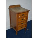 AN EDWARDIAN OAK BEDSIDE CHEST OF FOUR DRAWERS