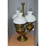 A THREE ARM OIL LAMP, having three oil reservoirs and shades, surrounding a central column with