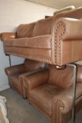 A FAWN LEATHER THREE PIECE LOUNGE SUITE consisting of a three seater sofa, width 227cm and two