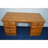 A MODERN PINE DRESSING TABLE, with seven various drawers