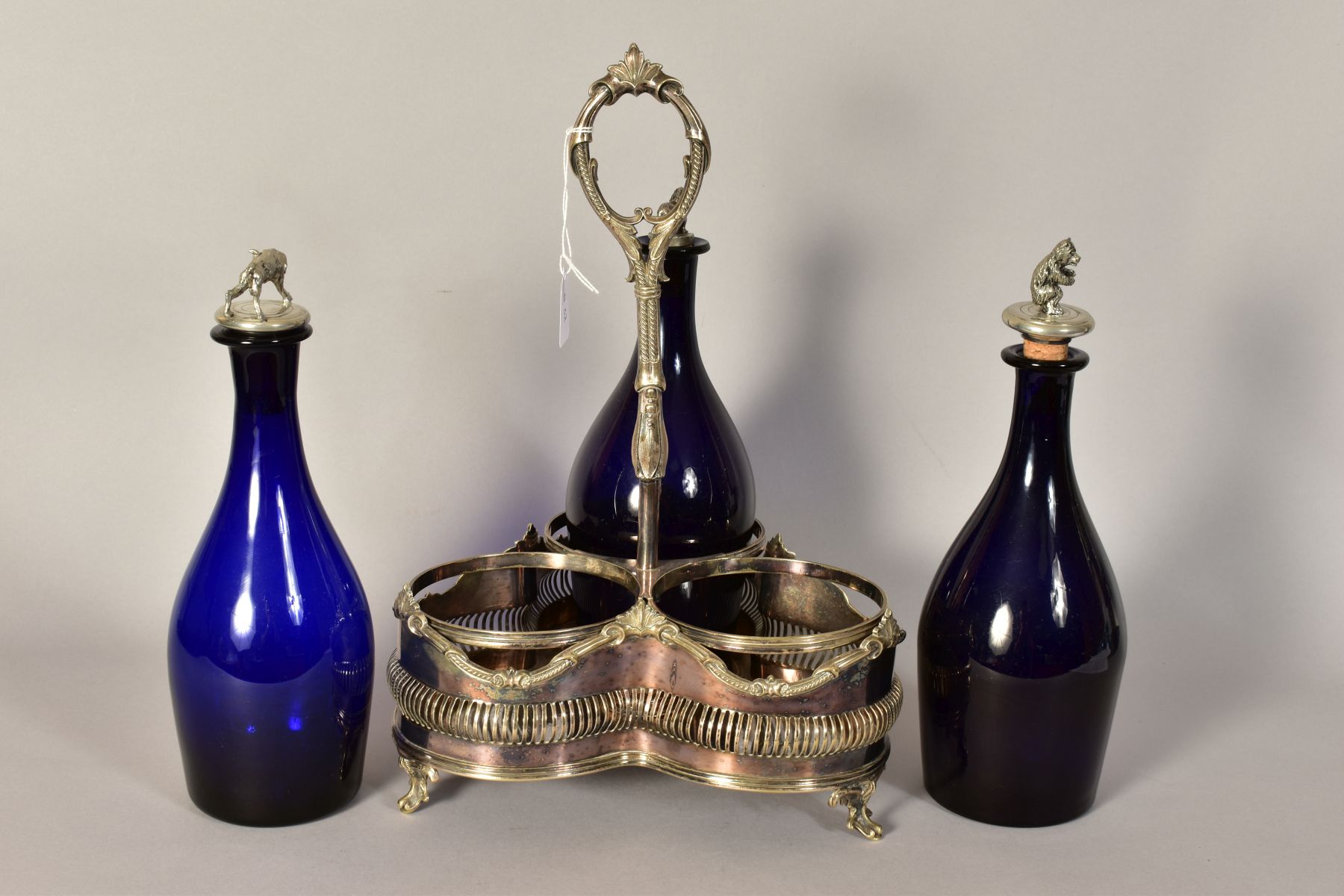 A VICTORIAN PLATED TREFOIL DECANTER STAND, containing three blue glass decanters with novelty - Image 3 of 3